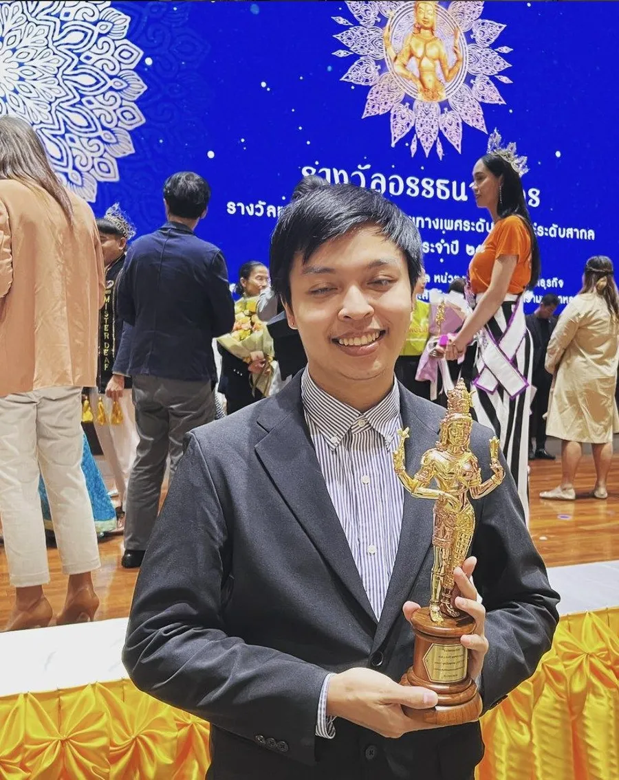 Arm holding the Ardhanareeswara Award trophy on stage