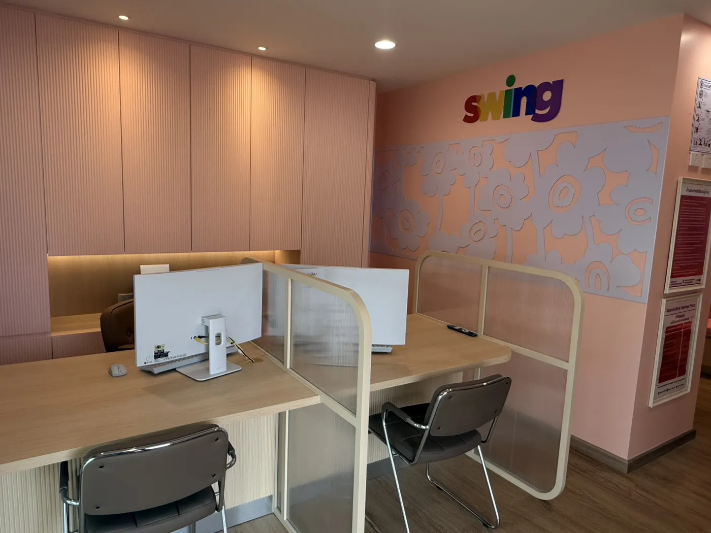 Inside a SWING clinic: a bright counselling room with the SWING logo on the wall