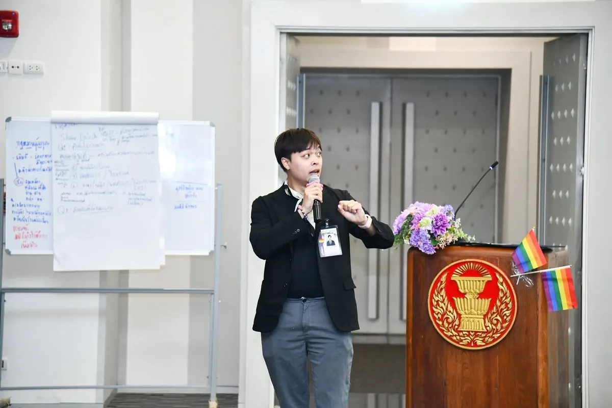 Arm speaking with a microphone at the Thai Parliament